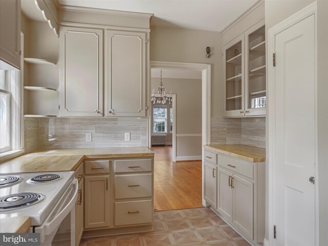 kitchen featuring light hardwood / wood-style floors, decorative light fixtures, radiator, and a wealth of natural light