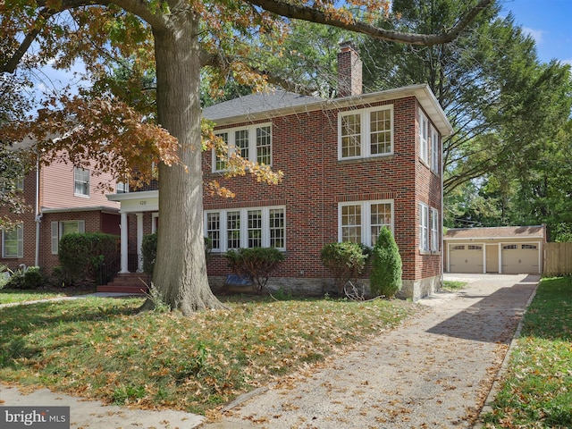 120 E Irvin Ave, Hagerstown, MD 21742 - view of front of house with an outbuilding, driveway, a chimney, a garage, and brick siding