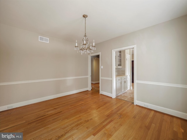 120 E Irvin Ave, Hagerstown, MD 21742 - unfurnished dining area featuring light wood finished floors, visible vents, baseboards, and an inviting chandelier
