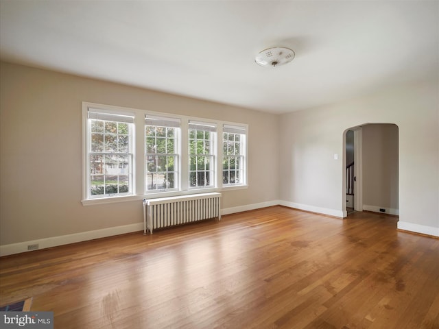 120 E Irvin Ave, Hagerstown, MD 21742 - spare room with radiator, wood finished floors, arched walkways, and baseboards
