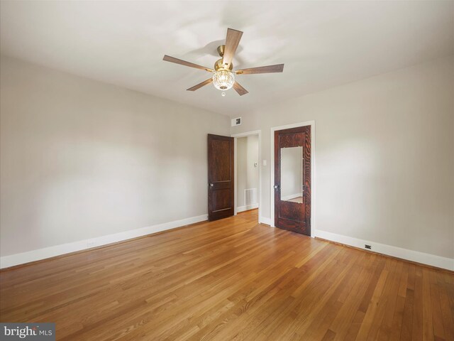 unfurnished room featuring light wood-type flooring and ceiling fan