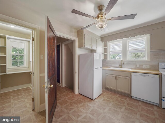 kitchen featuring tasteful backsplash, sink, white appliances, ceiling fan, and light parquet floors