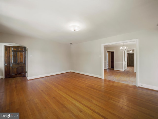 120 E Irvin Ave, Hagerstown, MD 21742 - unfurnished living room featuring baseboards, a chandelier, and hardwood / wood-style flooring