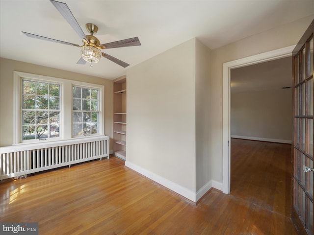 120 E Irvin Ave, Hagerstown, MD 21742 - unfurnished room featuring radiator, ceiling fan, baseboards, built in features, and hardwood / wood-style flooring