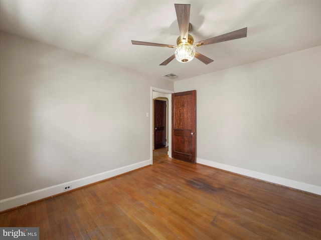 spare room featuring hardwood / wood-style floors and ceiling fan