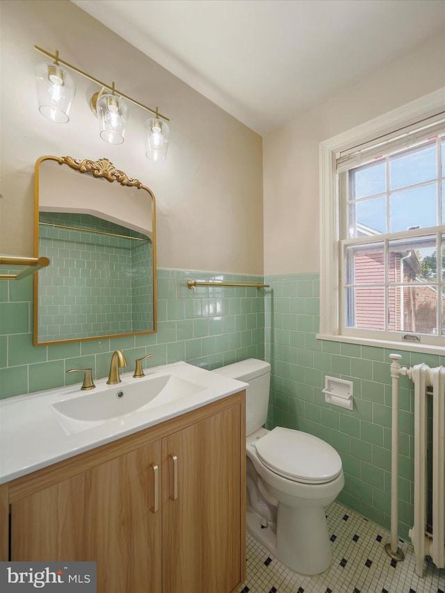 120 E Irvin Ave, Hagerstown, MD 21742 - half bathroom featuring vanity, radiator heating unit, tile patterned floors, toilet, and tile walls