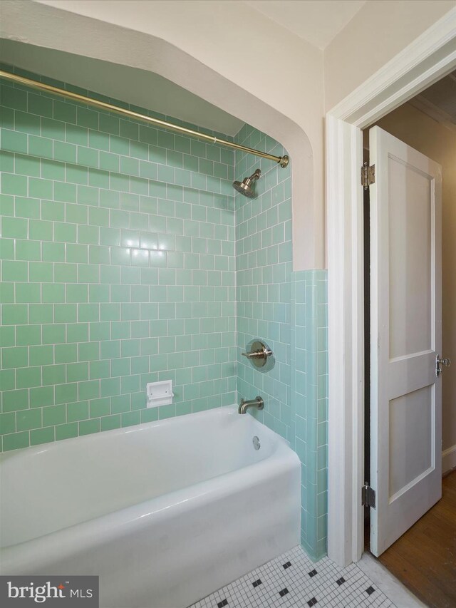 bathroom with tiled shower / bath combo and tile patterned floors