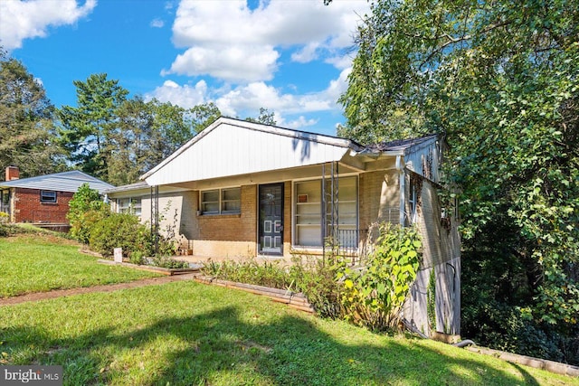 bungalow-style house featuring a front yard