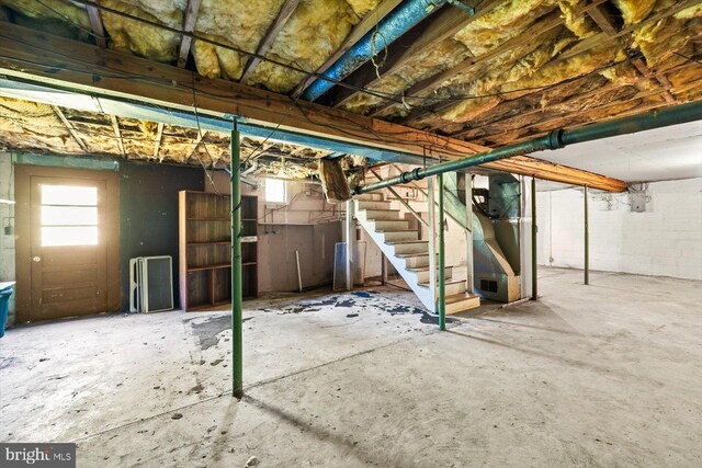 basement featuring heating unit and a wealth of natural light