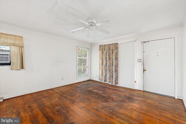 spare room with dark hardwood / wood-style flooring and ceiling fan