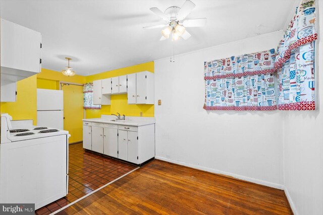 kitchen featuring dark wood-type flooring, sink, white cabinetry, white appliances, and ceiling fan