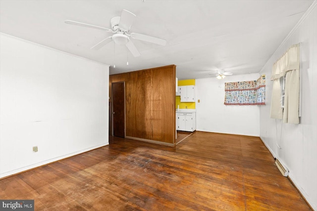 empty room with ceiling fan, dark hardwood / wood-style floors, and ornamental molding