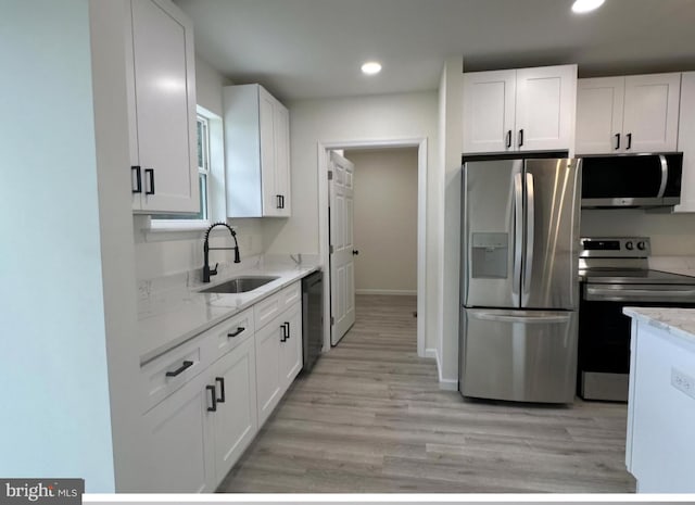 kitchen featuring light hardwood / wood-style flooring, stainless steel appliances, white cabinetry, and sink