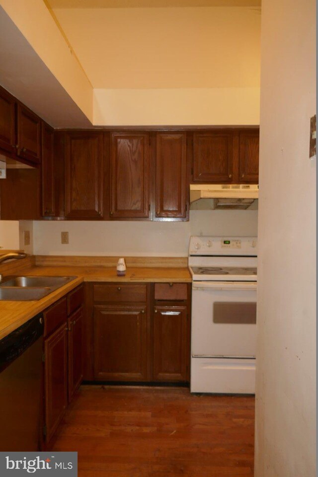 kitchen featuring dishwasher, white stove, wood counters, sink, and dark hardwood / wood-style flooring