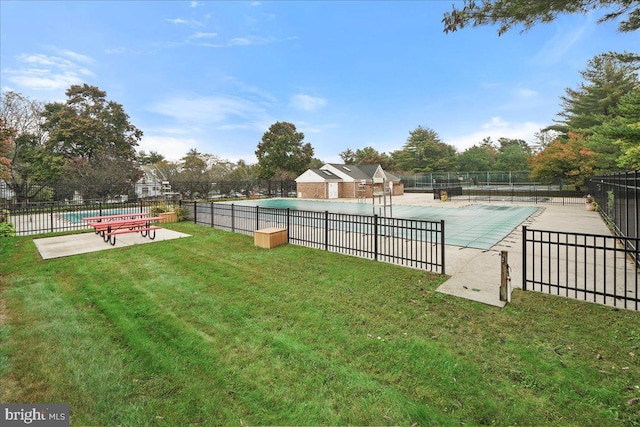 view of pool featuring a patio and a yard