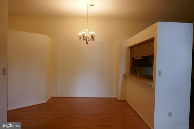 interior space featuring a chandelier and hardwood / wood-style floors