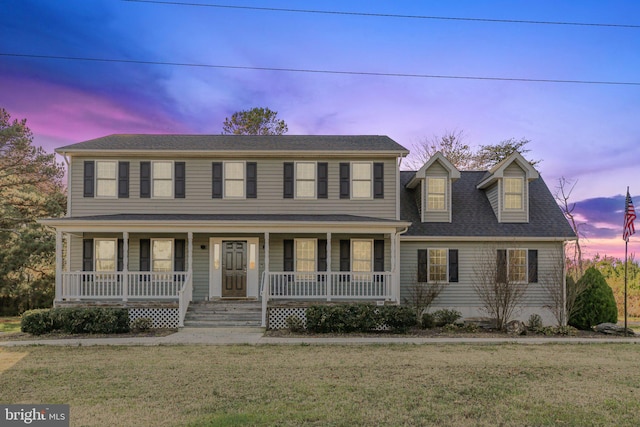 view of front facade featuring a yard and covered porch