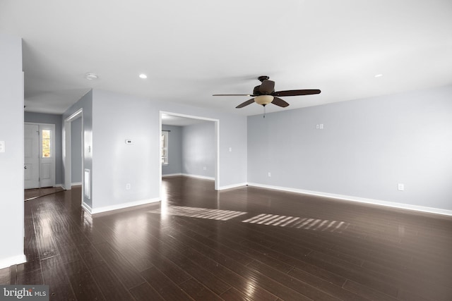 spare room with ceiling fan and dark hardwood / wood-style floors