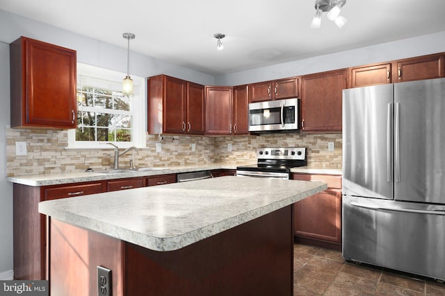 kitchen featuring tasteful backsplash, appliances with stainless steel finishes, pendant lighting, sink, and a center island