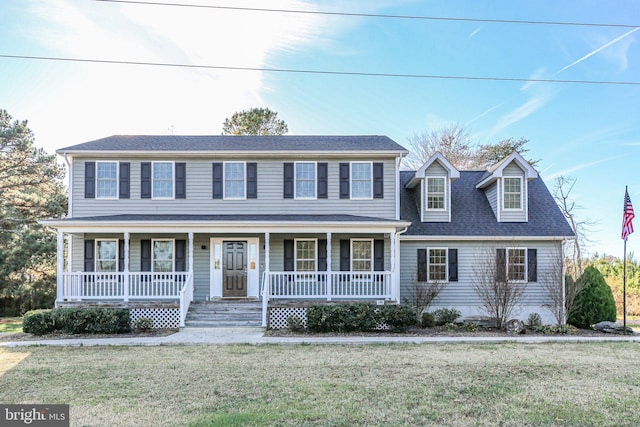 colonial-style house featuring a front yard and a porch