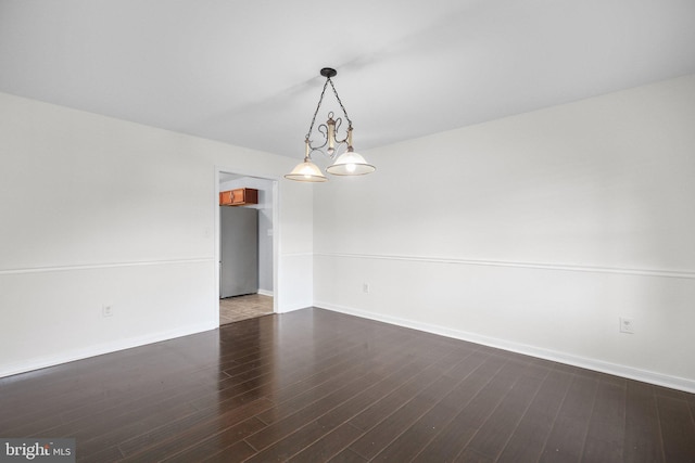 spare room with dark wood-type flooring