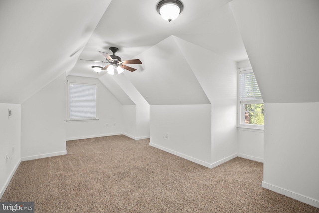 bonus room featuring light colored carpet, lofted ceiling, and ceiling fan