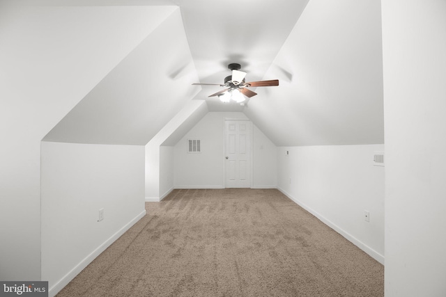 additional living space with ceiling fan, carpet flooring, and vaulted ceiling