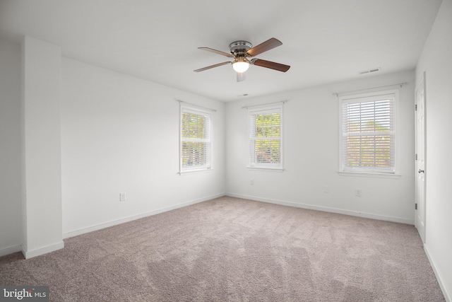 carpeted spare room with ceiling fan