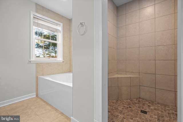 bathroom featuring tile patterned flooring and shower with separate bathtub