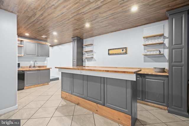 kitchen featuring wood ceiling, black dishwasher, light tile patterned floors, gray cabinetry, and butcher block countertops