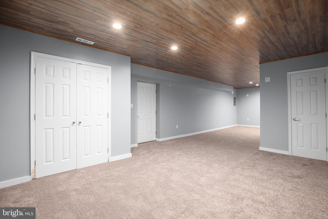 additional living space featuring carpet flooring and wood ceiling