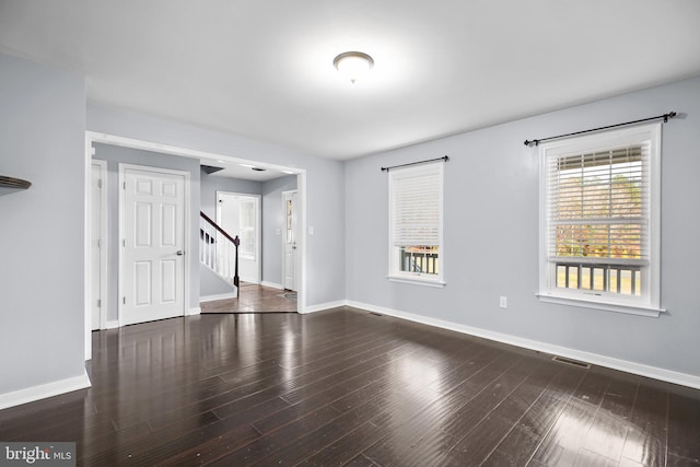 spare room with dark hardwood / wood-style floors