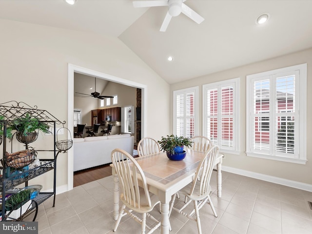 dining space featuring vaulted ceiling, ceiling fan, and light tile patterned floors