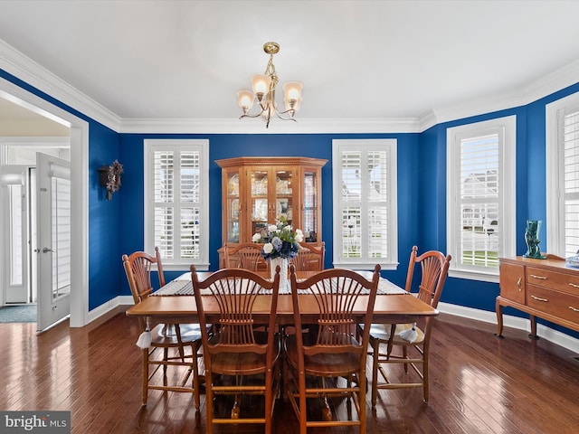 dining space featuring an inviting chandelier, crown molding, and dark hardwood / wood-style floors