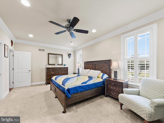 carpeted bedroom featuring ceiling fan and crown molding