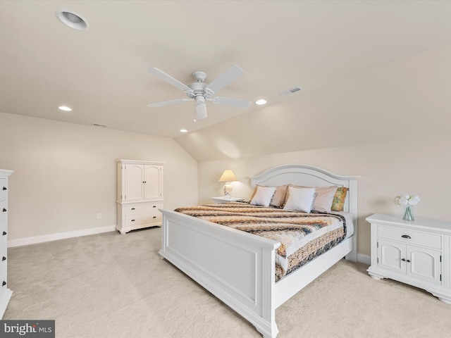 bedroom featuring light carpet, vaulted ceiling, and ceiling fan