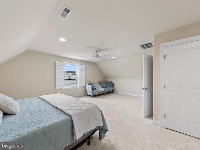 carpeted bedroom with vaulted ceiling and ceiling fan