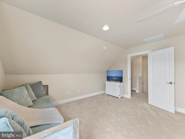 living area featuring light carpet and lofted ceiling