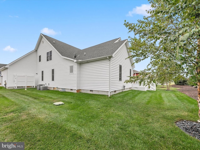 view of side of property with a lawn