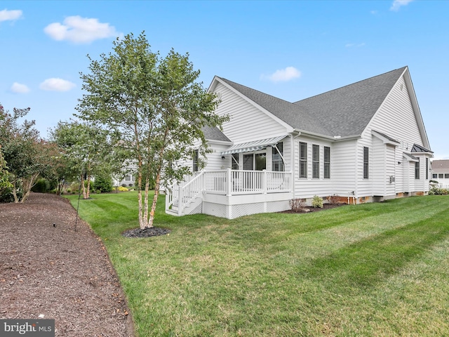 view of side of property with a lawn