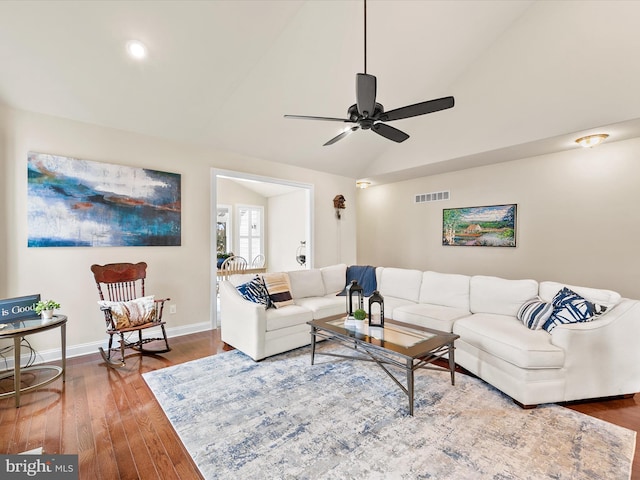 living room with ceiling fan, vaulted ceiling, and wood-type flooring