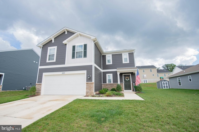 view of front of home with a garage, central AC unit, and a front yard