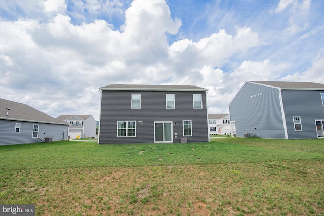 rear view of property featuring a yard