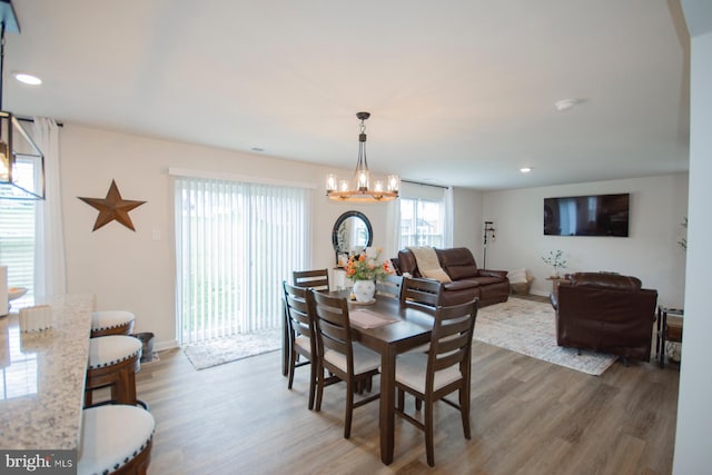 dining area featuring an inviting chandelier and dark wood-type flooring