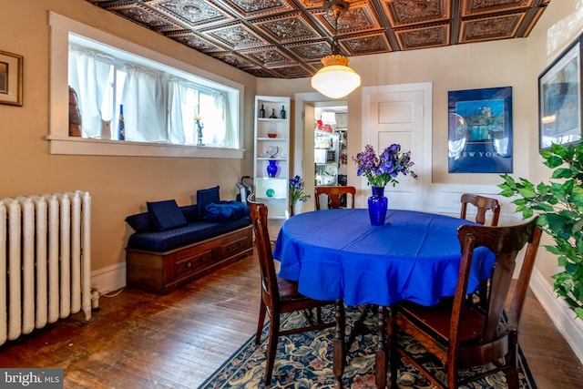 dining space with radiator and dark hardwood / wood-style floors