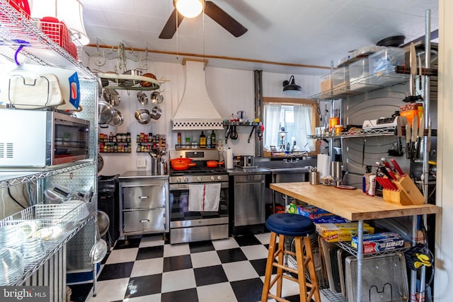 kitchen with ceiling fan, stainless steel appliances, and custom exhaust hood