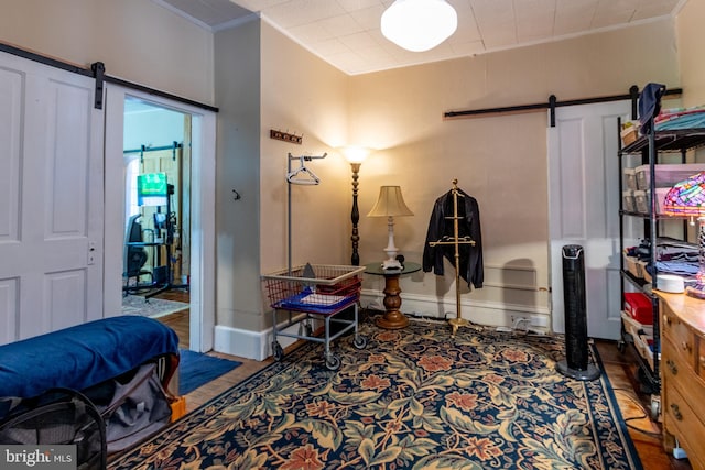 interior space featuring crown molding and a barn door