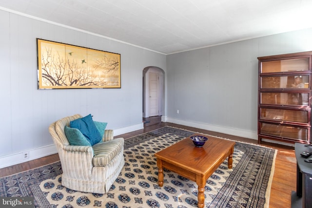 living area featuring hardwood / wood-style floors and crown molding