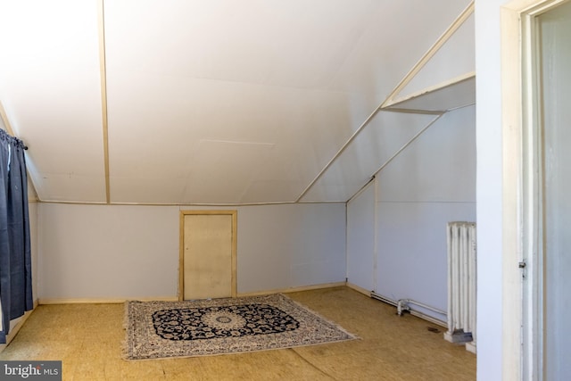 additional living space with lofted ceiling and radiator