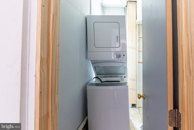 clothes washing area with stacked washer / drying machine